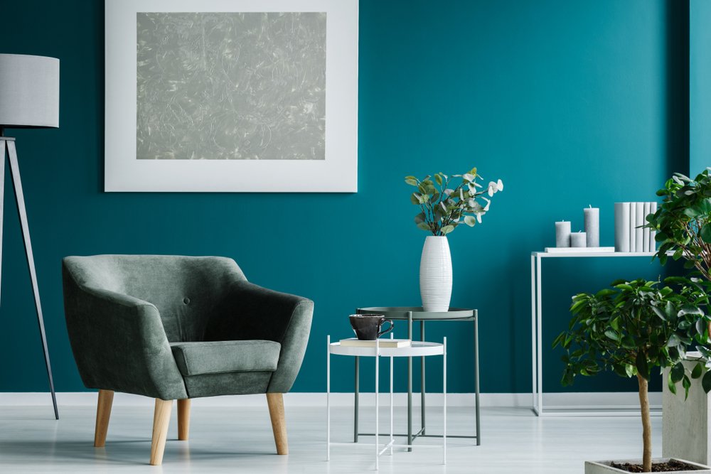 Green,Armchair,Against,Blue,Wall,With,Silver,Painting,In,Living Interior painting services Oakville